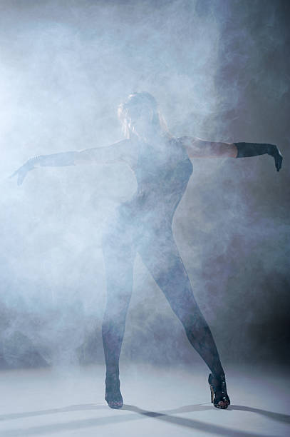 istock Woman dancing in a smoke. Studio 180588221