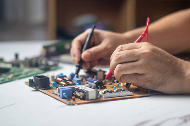 istock Technician using tool to measure circuit board, check and repair 1805899934