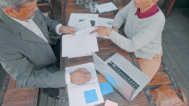Business people, documents and meeting in marketing, statistics or analytics above on table. Top view of businessman and woman with paperwork in planning, team strategy or collaboration at workplace