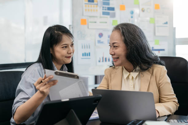 istock Businessmen write project ideas and use laptops to edit papers for brainstorming sessions with partners in the office. 1805912522