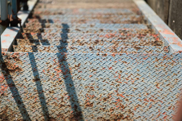 Rustic metal with roughly surface of the stairway platform, the way down to canal. Industrial structure equipment object.