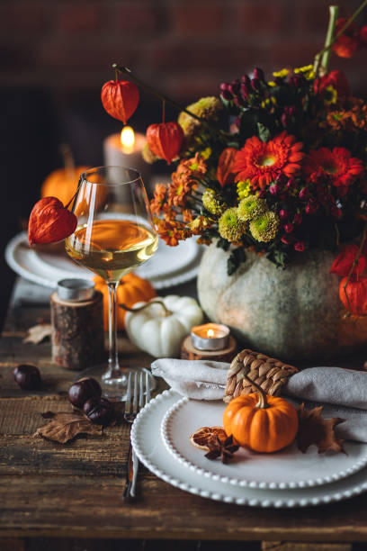 istock Fall mood, romantic date outdoors in the garden, candlelight dinner for a couple. Private wedding for two. Pumpkin countryside decor, red dahlia, cheese plate, grapes. Gourmet food, elegant setting 1805931489