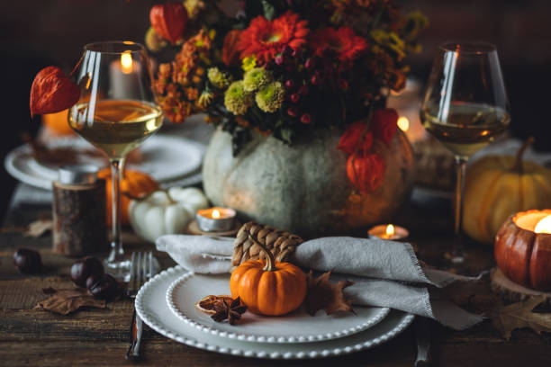 istock Fall mood, romantic date outdoors in the garden, candlelight dinner for a couple. Private wedding for two. Pumpkin countryside decor, red dahlia, cheese plate, grapes. Gourmet food, elegant setting 1805932065
