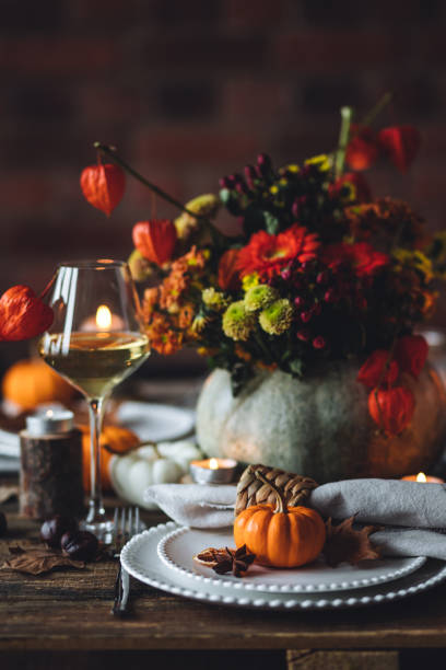 istock Fall mood, romantic date outdoors in the garden, candlelight dinner for a couple. Private wedding for two. Pumpkin countryside decor, red dahlia, cheese plate, grapes. Gourmet food, elegant setting 1805932623