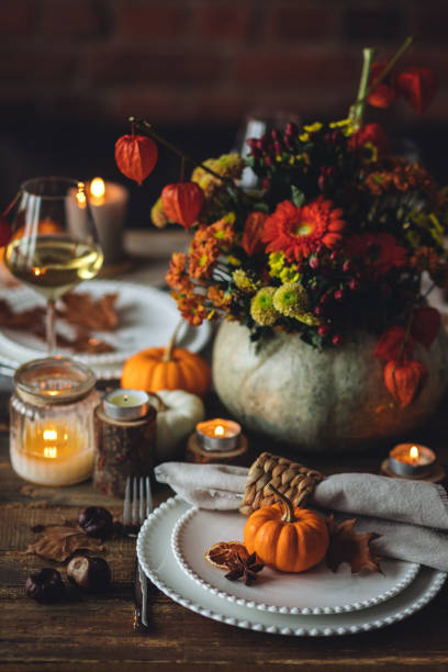 istock Fall table decoration with pumpkins, wine. Family thanksgiving dinner arrangement outdoors in the garden. Countryside style, simple handmade setting, autumn mood 1805933260