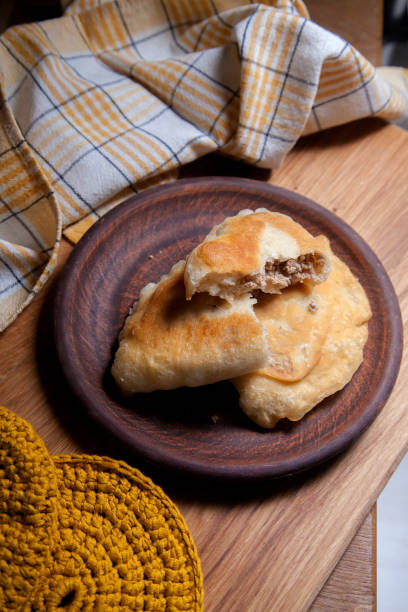 istock Clay plate of fried meat pies on wooden table 1805936663