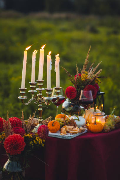 istock Fall table decoration with pumpkins, wine. Family thanksgiving dinner arrangement outdoors in the garden. Countryside style, simple handmade setting, autumn mood 1805959025
