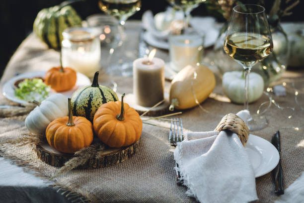 istock Fall table decoration with pumpkins, wine. Family thanksgiving dinner arrangement outdoors in the garden. Countryside style, simple handmade setting, autumn mood 1805964209