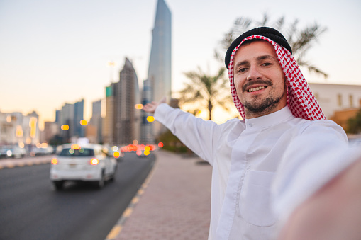 Selfie of a young sheik in the city during sunset.