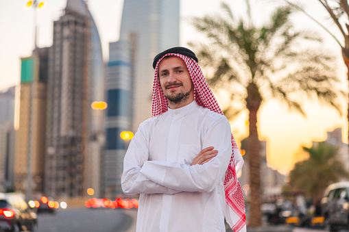 Portrait of a young sheik in the city during sunset.