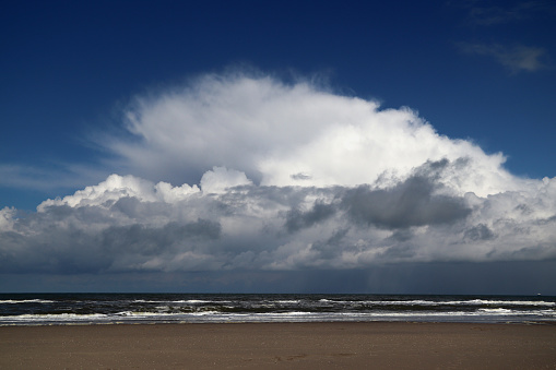 Light clouds above darker, heavy clouds above the North Sea in the Netherlands