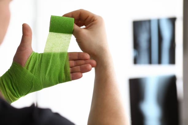 istock Man rewinds his hand with bandage on an x-ray 1805999933