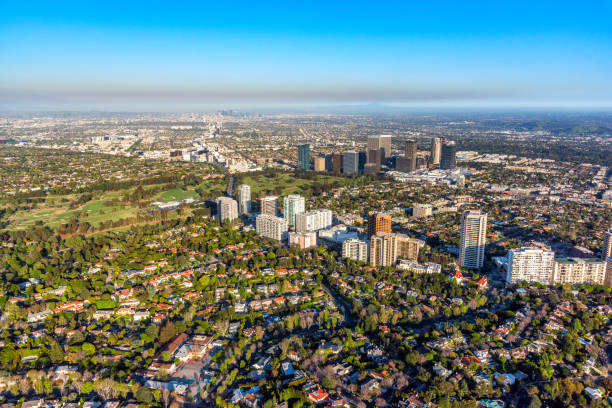 Wide angle view of the Los Angeles including the skyline of Century city in the foreground along the LA Country Club, Wilshire Blvd, and the downtown skyline in the distance shot via helicopter from an altitude of about 1200 feet.