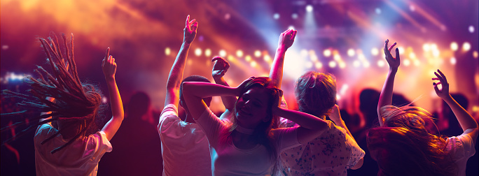 Banner. crowd of young attractive people, students on summer music festival dancing and singing in neon light and stage smoke. Concept of party, festivals, concerts, music and dance, fun, adventures.