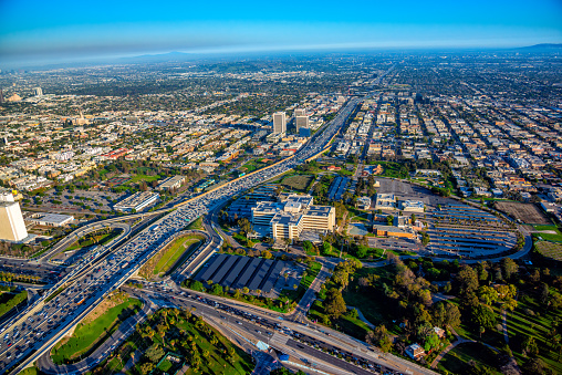 Interstate 405 through Los Angeles with the intersection of Wilshire Blvd. below and the Los Angeles VA hospital prominently visible in the foreground.