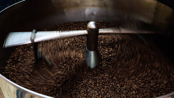 istock coffee beans and roasted spinning cover professional machine, close up to soft focus, take low speed photo to need movement and coffee beans detail concept, 1806028762