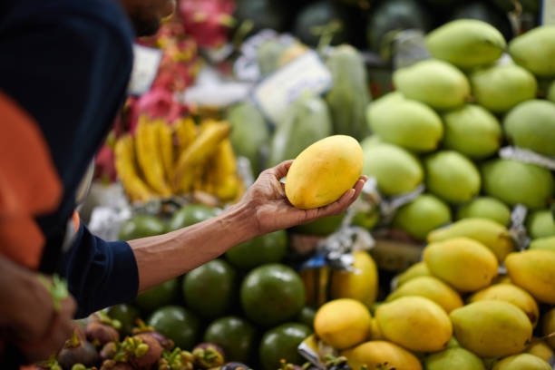 istock Customer Buying Mangoes 1806030668