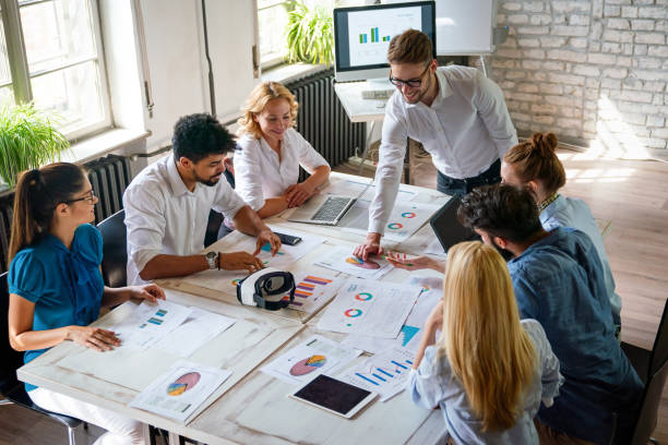 istock Group of multiethnic business people brainstorming, analyzing financial reports in office 1806032835