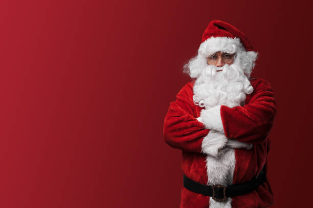 istock Confident Santa Claus with a stern look stands with arms folded 1806034048