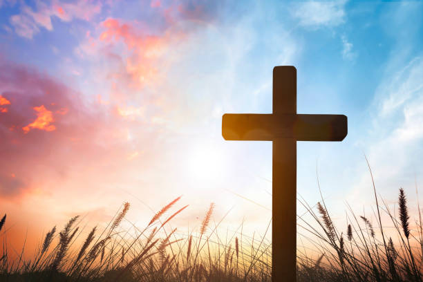istock The cross on grass with sunset in the sky background 1806044341