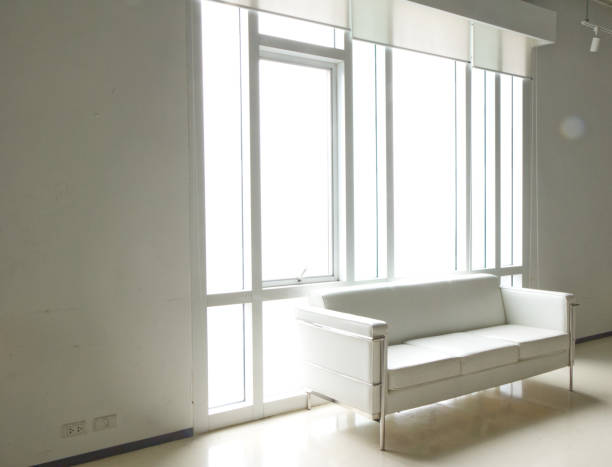 istock White sofa in room window modern interior design background home 1806045492