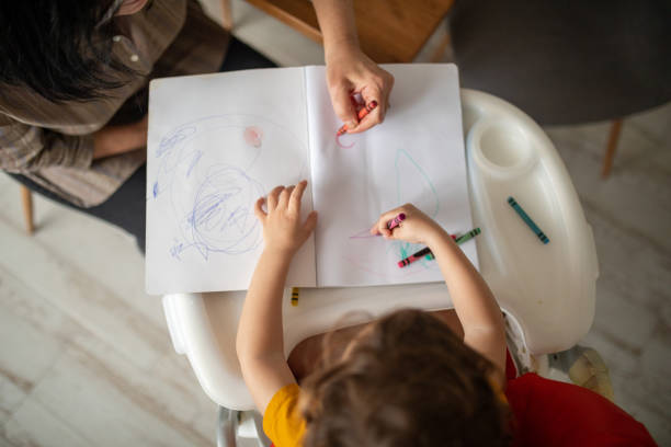 istock Senior lady teaching her grandson drawing 1806046045