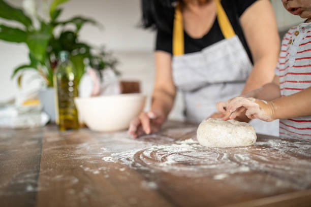 istock Little boy making bread with his grandma 1806053323