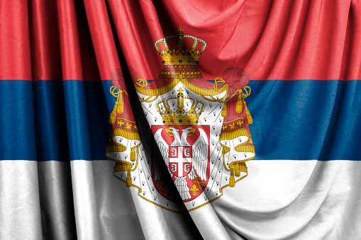 Flag of Serbia with coat of arms waving in the wind 3D illustration