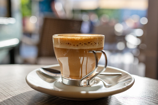 Dive into the world of morning bliss with this close-up view of a coffee cup. The soothing aroma and elegant design create the ideal ambiance for your daily caffeine fix in a charming cafe.