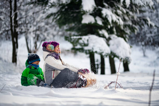 istock Kids enjoying tobogganing on winter evening. 1806068293