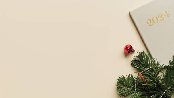 istock 2024 planner and Christmas tree branch, top view. New Year holiday background, space for text 1806078200