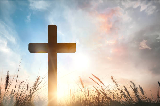 istock The cross on grass with sunset in the sky background 1806078889