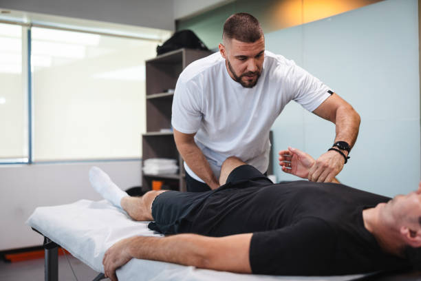istock Young masseur massaging his client in his office 1806083200