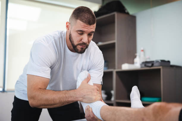 istock Young masseur massaging his client in his office 1806083740