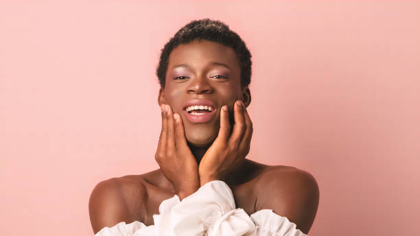 istock Happy gentle transgender person touching cheeks in studio 1806089640