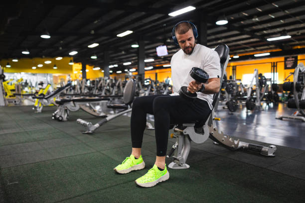 istock Handsome young man lifting weights in the gym 1806090889