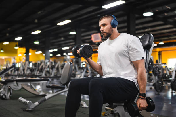 istock Handsome young man lifting weights in the gym 1806090891
