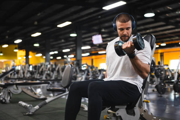 istock Handsome young man lifting weights in the gym 1806091194