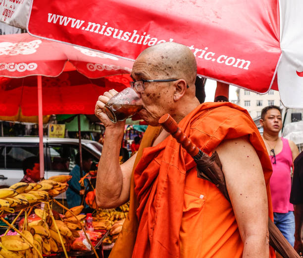 Yangon, Myanmar - Feb 26, 2016. A monk at street market in Yangon, Myanmar. Yangon is Myanmar largest city and its most important commercial centre.