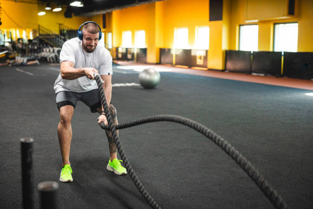istock Young man working with ropes in the gym 1806098495