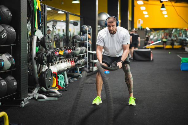 istock Young man working with ropes in the gym 1806099031