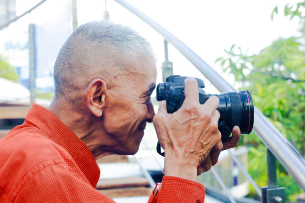 istock Profile portrait of mature thai man with camera 1806103442