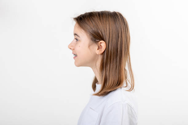 istock Brunette girl smiling with braces on her teeth on a white background isolated. 1806125013