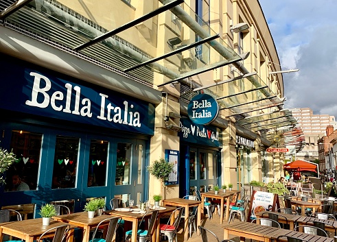 Nottingham, UK - October 6, 2019: Bella Italia restaurant offering Italian cuisine with outdoor wooden tables in Nottingham, UK.