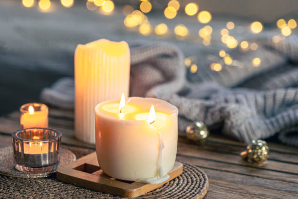 istock Cozy background with burning candles and knitted element. 1806128141