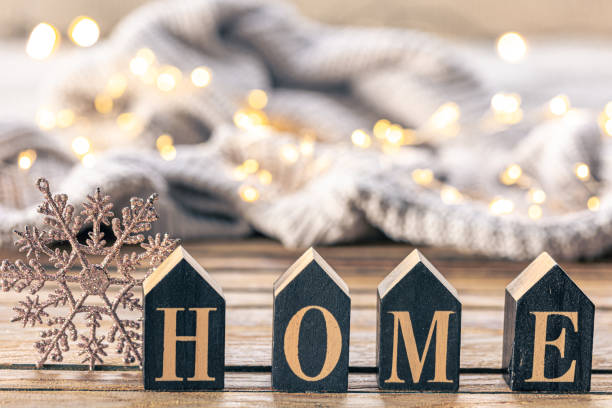 istock Cozy background with decorative word Home on a blurred background with garland. 1806128300