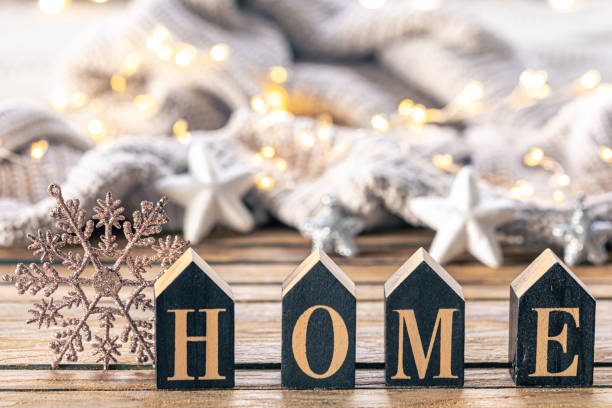 istock Cozy background with decorative word Home on a blurred background with garland. 1806128457