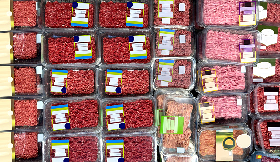 Ground Beef at supermarket refrigerator. View from above. Brand-less packaging mockup and illustration ideal for graphic designers, architects and interior designers.