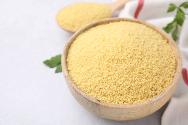 istock Raw couscous in bowl on light table, closeup 1806142546