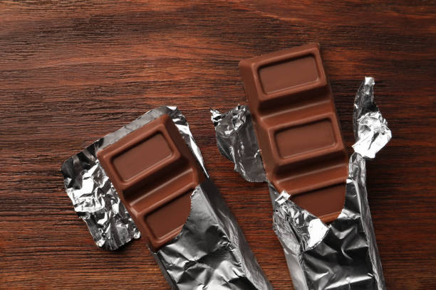 istock Tasty chocolate bars on wooden table, flat lay 1806154792